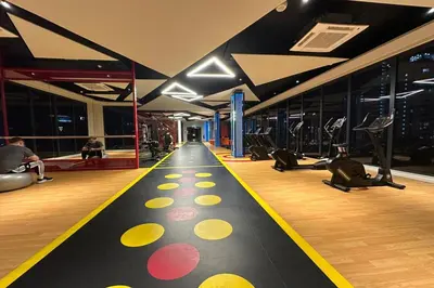 a gym with a fitness floor with yellow and red circles at Majestic Residence KLCC by Luxe in Gua Sai