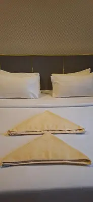 two beds with white pillows and a blanket on them at Good Residences at Star KLCC in Kuala Lumpur