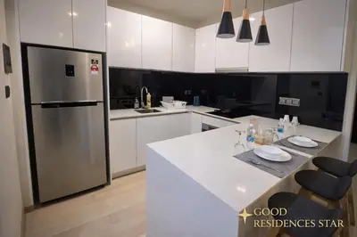 a kitchen with a refrigerator and a white counter top at Good Residences at Star KLCC in Kuala Lumpur