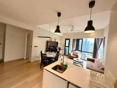 a kitchen and living room with a couch and a table at Good Residences at Star KLCC in Kuala Lumpur