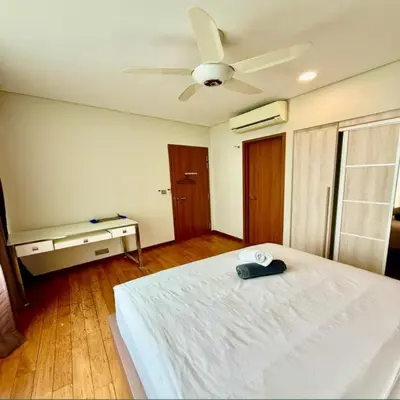 a bedroom with a white bed and a ceiling fan at Sky suites klcc by Ryan in Kuala Lumpur