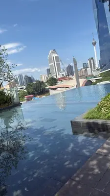 a pool of water in a city with buildings at KL Sky Suite By Opus Residence in Kuala Lumpur