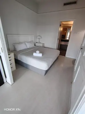 a bedroom with a large bed with a white bedvisor at Healthy suite At Times Square KL in Kuala Lumpur