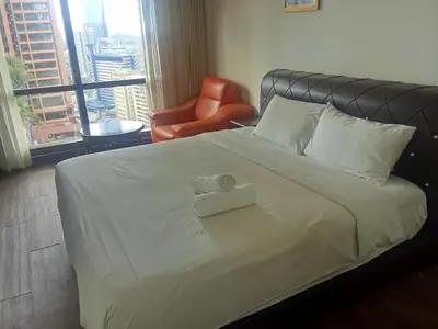 a bedroom with a bed with a towel on it at Healthy suite At Times Square KL in Kuala Lumpur
