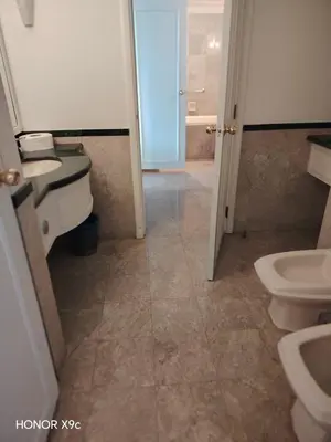a bathroom with a sink and a toilet and a door at Healthy suite At Times Square KL in Kuala Lumpur