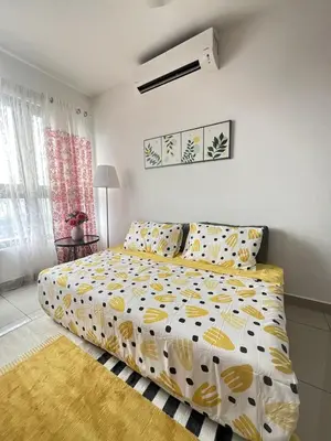 a bedroom with a bed with a yellow and white comforter at Kuala Lumpur M Vertica Retro 3BR with Car park in Kuala Lumpur