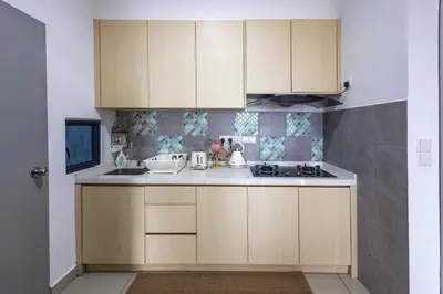 a kitchen with wooden cabinets and a stove at Kuala Lumpur M Vertica Retro 3BR with Car park in Kuala Lumpur