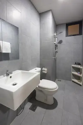 a bathroom with a white toilet and a sink at Kuala Lumpur M Vertica Retro 3BR with Car park in Kuala Lumpur