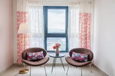 two chairs and a table in front of a window at Kuala Lumpur M Vertica Retro 3BR with Car park in Kuala Lumpur