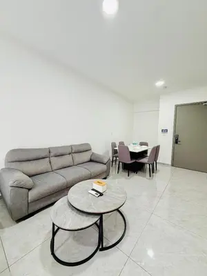 a living room with a couch and a table at Agile Bukit Bintang TRX By Glanza Suites in Kuala Lumpur
