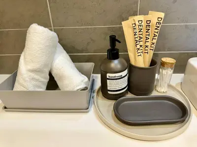 a bathroom counter with toiletries and a container of toilet paper at Robertson 1R1B Pinwu Bkt Bintang|Chinatown|LRT in Kuala Lumpur