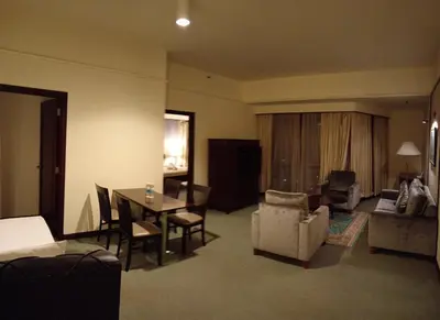 a living room with a table and chairs and a dining room at Town suites Times Square in Kuala Lumpur