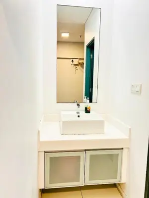 a bathroom with a white sink and a mirror at Mercu Summer suites KLCC by Classy in Kuala Lumpur