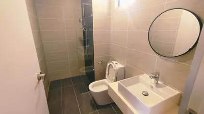 a bathroom with a sink and a mirror and a toilet at trion in Kuala Lumpur