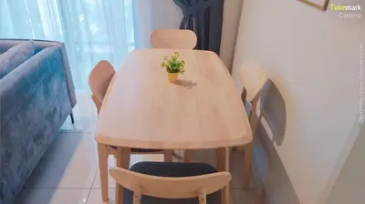 a wooden table with two chairs and a plant on it at trion in Kuala Lumpur