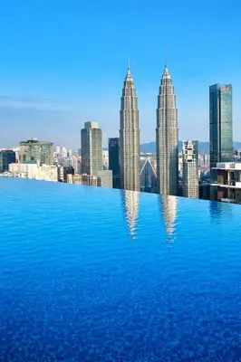 a view of a city skyline from a swimming pool at Eaton Residences KL City Center in Kuala Lumpur