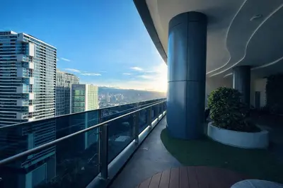 a balcony of a building with a view of the city at Eaton Residences KL City Center in Kuala Lumpur