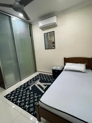 a bedroom with a bed and a mirror in it at Gombak Fatin Homestay in Kuala Lumpur