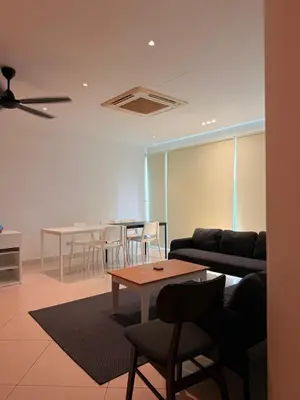 a living room with a couch and tables and chairs at Poshpack Skyline Hostel in Kuala Lumpur
