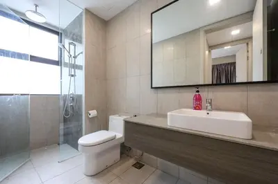 a bathroom with a sink and a toilet and a mirror at Elegant Skyline Suite # Datum Jelatek near KLCC in Kampong Datok Keramat