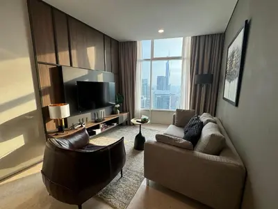 a living room with a couch and a television at Tomato Homestay By Sky Suites Klcc in Kuala Lumpur