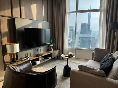a living room with a large flat screen tv at Tomato Homestay By Sky Suites Klcc in Kuala Lumpur