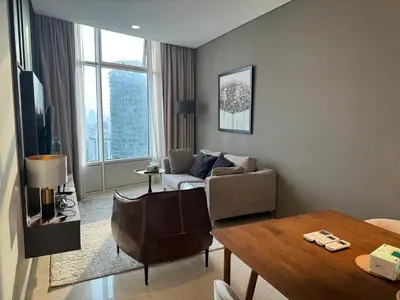 a living room with a couch and a table at Tomato Homestay By Sky Suites Klcc in Kuala Lumpur
