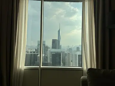 a window in a hotel room with a view of a city at Tomato Homestay By Sky Suites Klcc in Kuala Lumpur