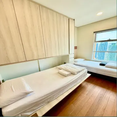 a bedroom with two beds and a window at Sky suites klcc by sky view in Kuala Lumpur