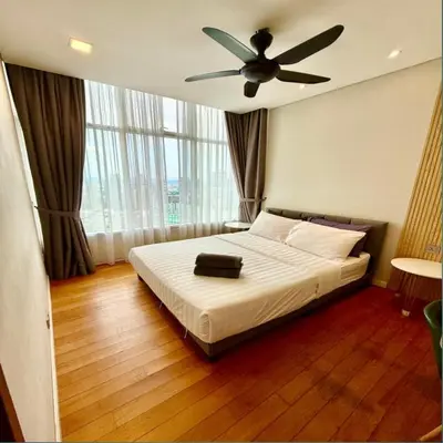 a bedroom with a bed with a ceiling fan at Sky suites klcc by sky view in Kuala Lumpur