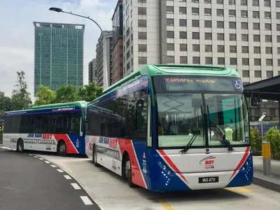 two buses parked next to each other on a street at The Forum Kuala Lumpur in Kuala Lumpur