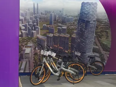 two bikes parked in front of a picture of a city at The Forum Kuala Lumpur in Kuala Lumpur