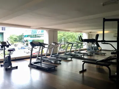 a gym with a row of treadmills and ellipticals at The Forum Kuala Lumpur in Kuala Lumpur