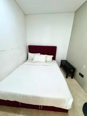 a bedroom with a large white bed with a red headboard at Vortex suites Near Klcc By I&J in Kuala Lumpur