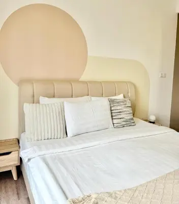 a bedroom with a large white bed with an arch above it at The Agile Residence By Signature in Kuala Lumpur