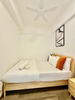 a bedroom with a bed with a ceiling fan at The Agile Residence By Signature in Kuala Lumpur