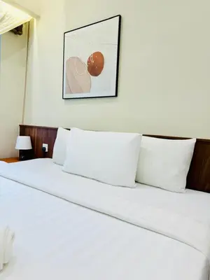 a white bed with white pillows in a bedroom at The Agile Residence By Signature in Kuala Lumpur