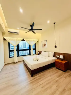 a bedroom with a bed and a ceiling fan at The Agile Residence By Signature in Kuala Lumpur