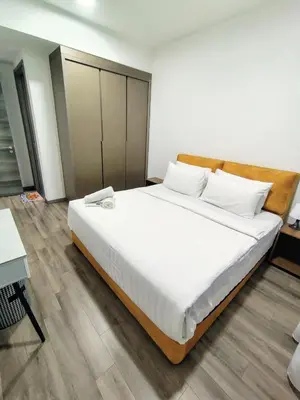 a bedroom with a large bed with white sheets at Agile suits of Kuala Lumpur in Kuala Lumpur