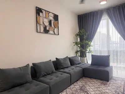 a living room with a gray couch in front of a window at 3 Bedrooms KLCC View PlazaRah,Kg Baru next to Rembayung in Kuala Lumpur