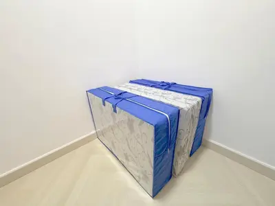 a blue suitcase sitting against a white wall at 3 Bedrooms KLCC View PlazaRah,Kg Baru next to Rembayung in Kuala Lumpur