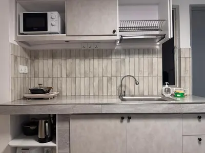 a kitchen with a sink and a microwave at 3 Bedrooms KLCC View PlazaRah,Kg Baru next to Rembayung in Kuala Lumpur