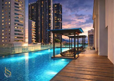a swimming pool on the roof of a building with a city at LUXORA SUITE's REIZZ RESIDENCE in Kuala Lumpur