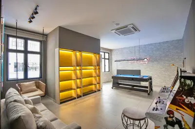 a living room with a couch and a pool table at Skyline Kuala Lumpur near Lalaport by Cityscape in Kuala Lumpur