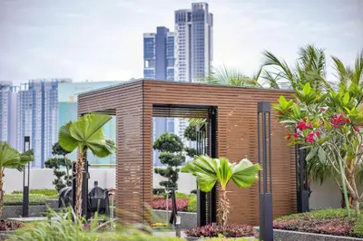 a small wooden building with palm trees in front of a city at Skyline Kuala Lumpur near Lalaport by Cityscape in Kuala Lumpur