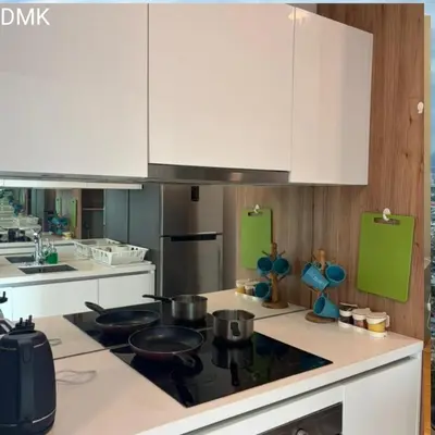 a kitchen with white cabinets and a stove top oven at vortex luxury APATMENT BY FRINDSHIP in Kuala Lumpur