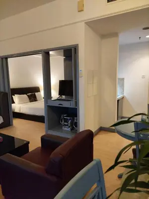 a living room with a couch and a bed and a mirror at Elements apartment service at Times Square in Kuala Lumpur