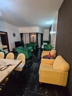 a hotel room with couches and a table and chairs at Elements apartment service at Times Square in Kuala Lumpur