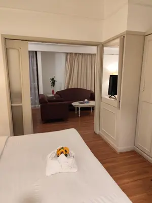 a hotel room with a bed with a flower on it at Elements apartment service at Times Square in Kuala Lumpur