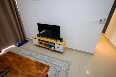 a living room with a flat screen tv on a stand at M Arisa Sentul by A&T in Kuala Lumpur
